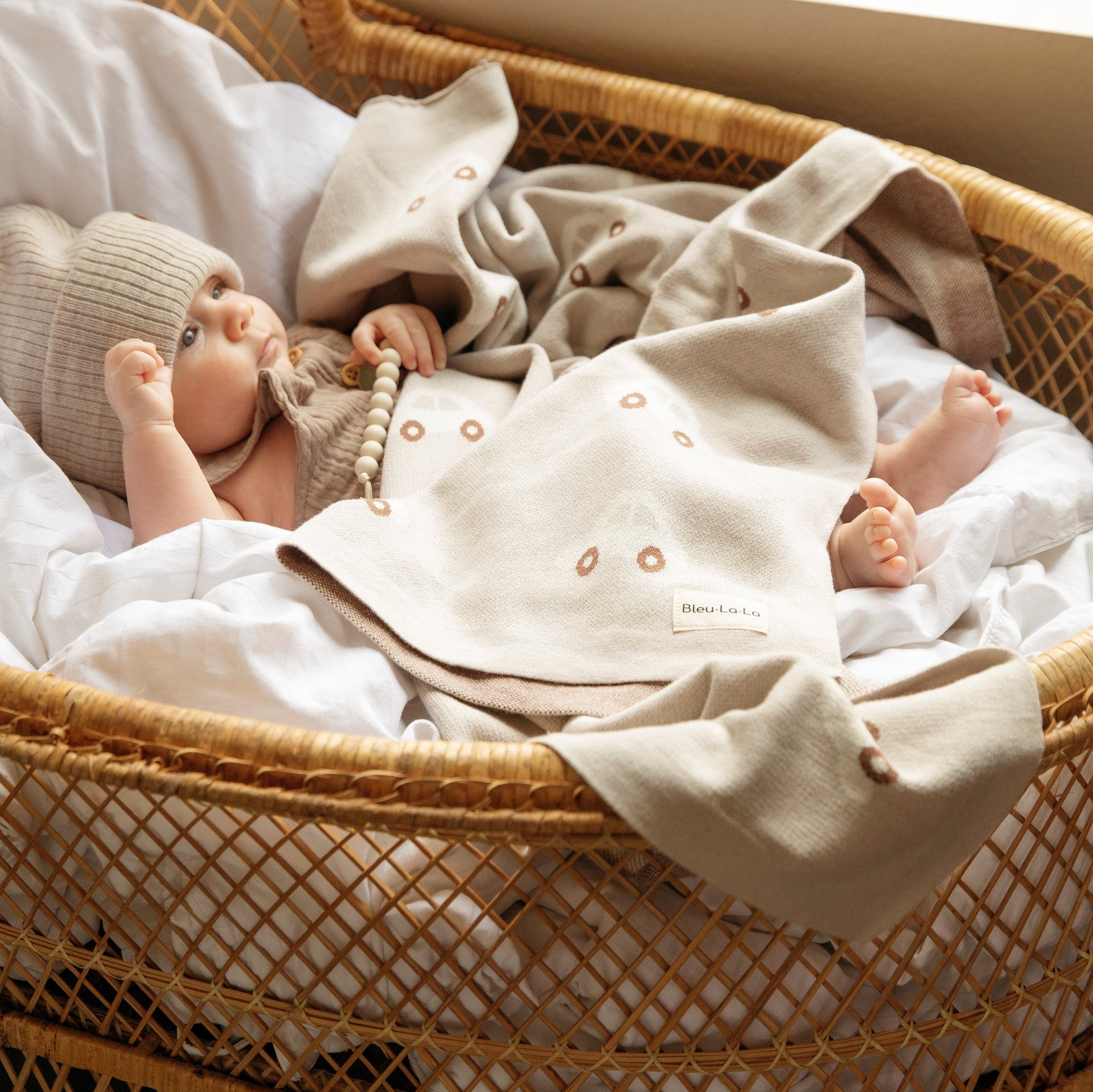 Baby in a wicker basket with a blanket