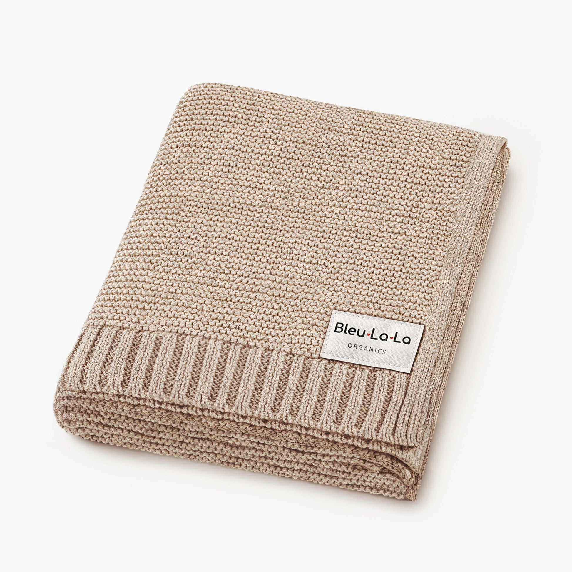 Beige knitted blanket with a visible Blue-La-La label on a white background