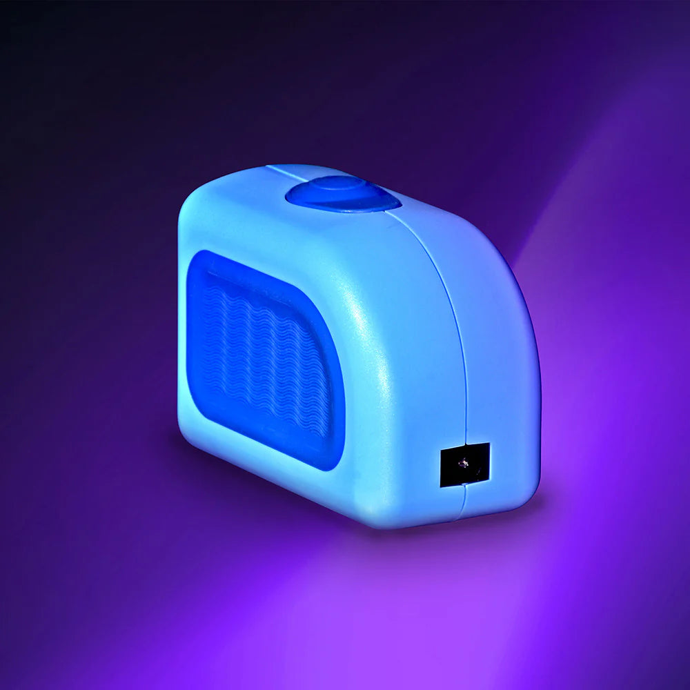 The Lil Nipper Adult electric nail clipper, conveniently rechargeable for long-lasting use. Shows the charging area on product with purple gradient background.