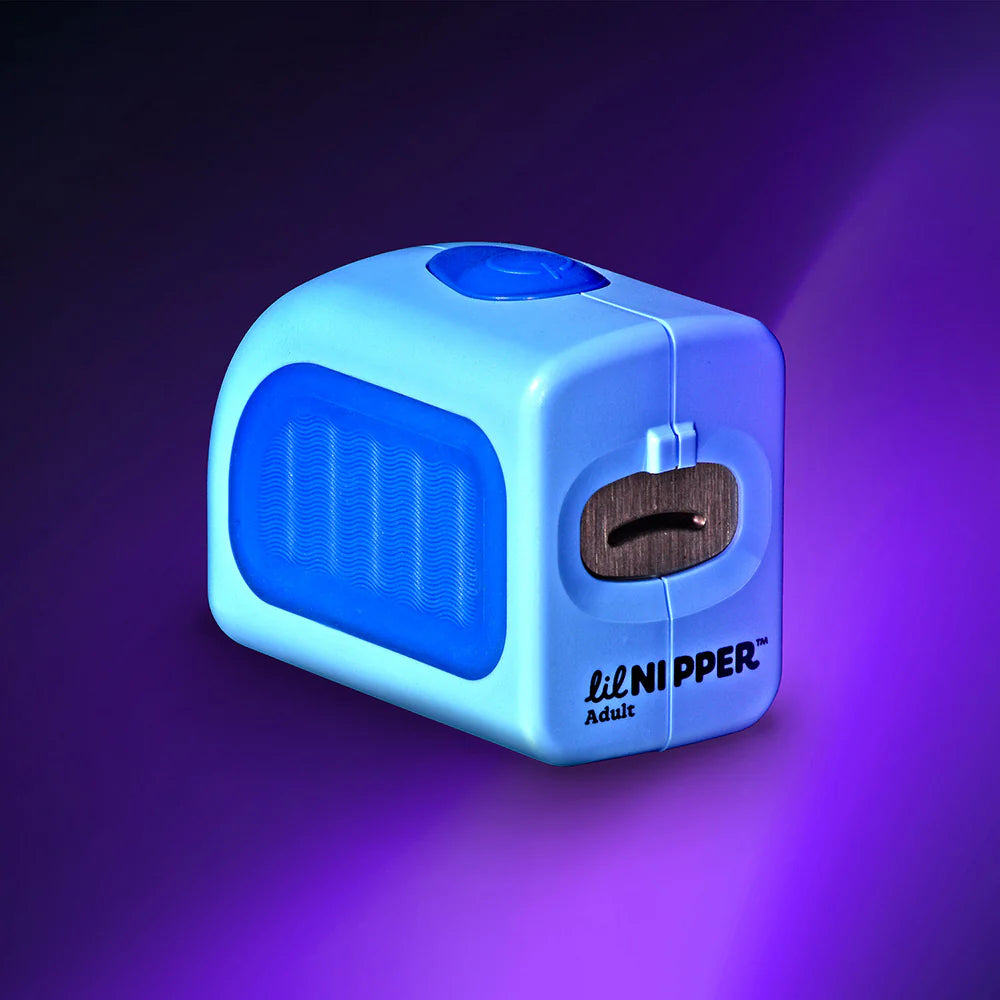 The Lil Nipper Adult electric nail clipper, designed for safe and effortless trimming. Blue color with purple background. Really sharp image.