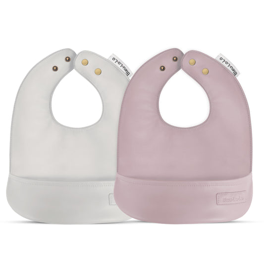 Two baby bibs, one white and one pink, with 'Blublu' branding on a white background.