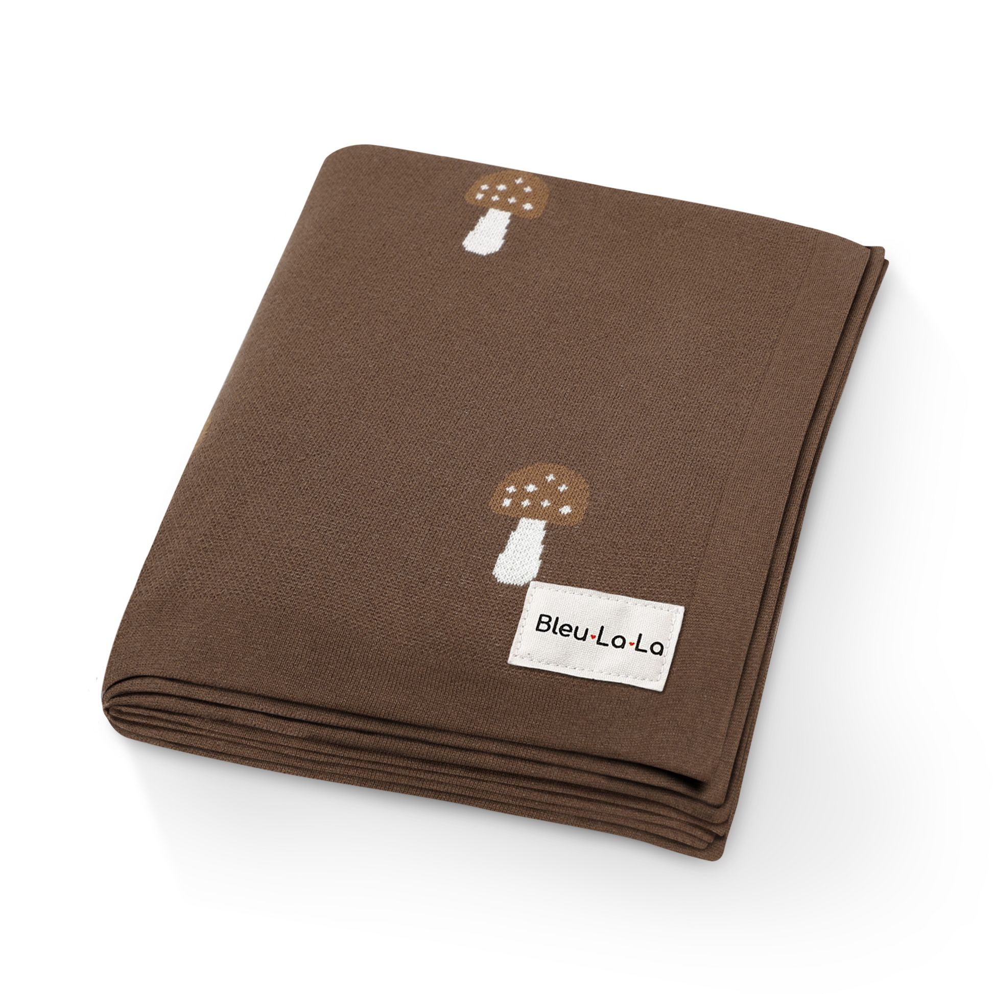 Close-up of luxury brown knit mushroom swaddle blanket showing soft texture and mushroom details