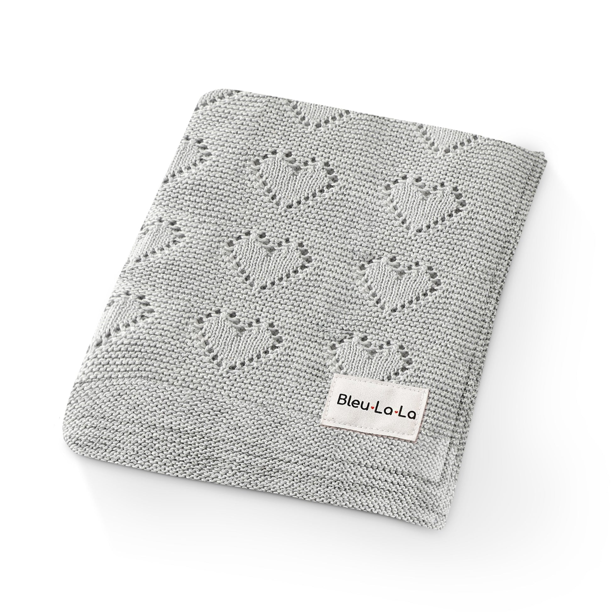 Gray knitted blanket with heart patterns and a visible Bleu-la-la  label on a white background
