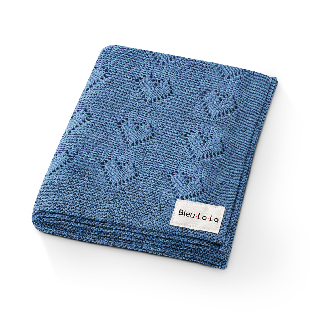 Blue knitted blanket with embroidered patterns on a white background, featuring the brand 'Bleu La La'.