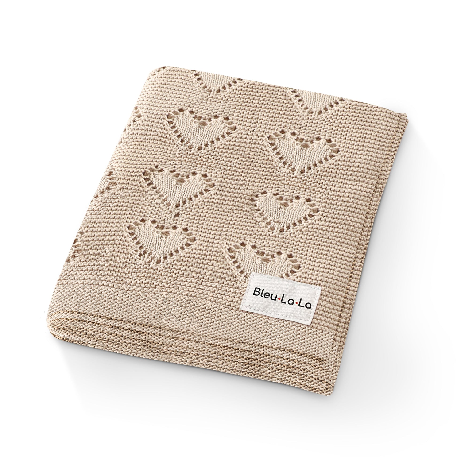 Beige knitted blanket with butterfly pattern and 'Bleu La La' label on a white background