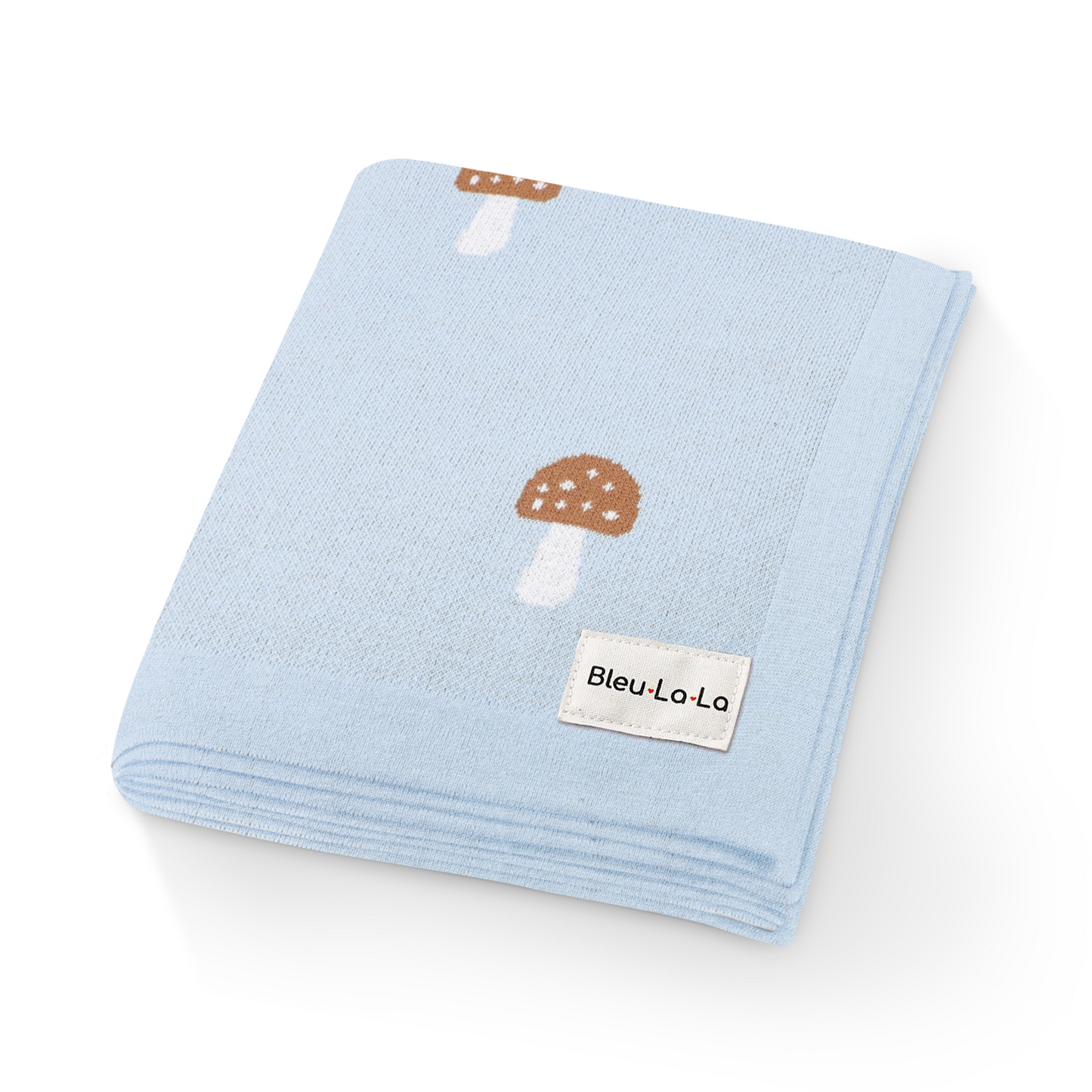 Close-up of luxury blue knit mushroom swaddle blanket showing soft texture and mushroom details