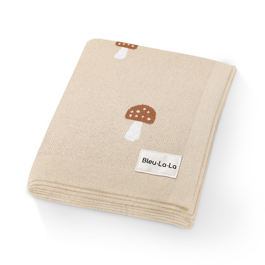 Beige towel with mushroom design and 'Bleu La La' label on a white background