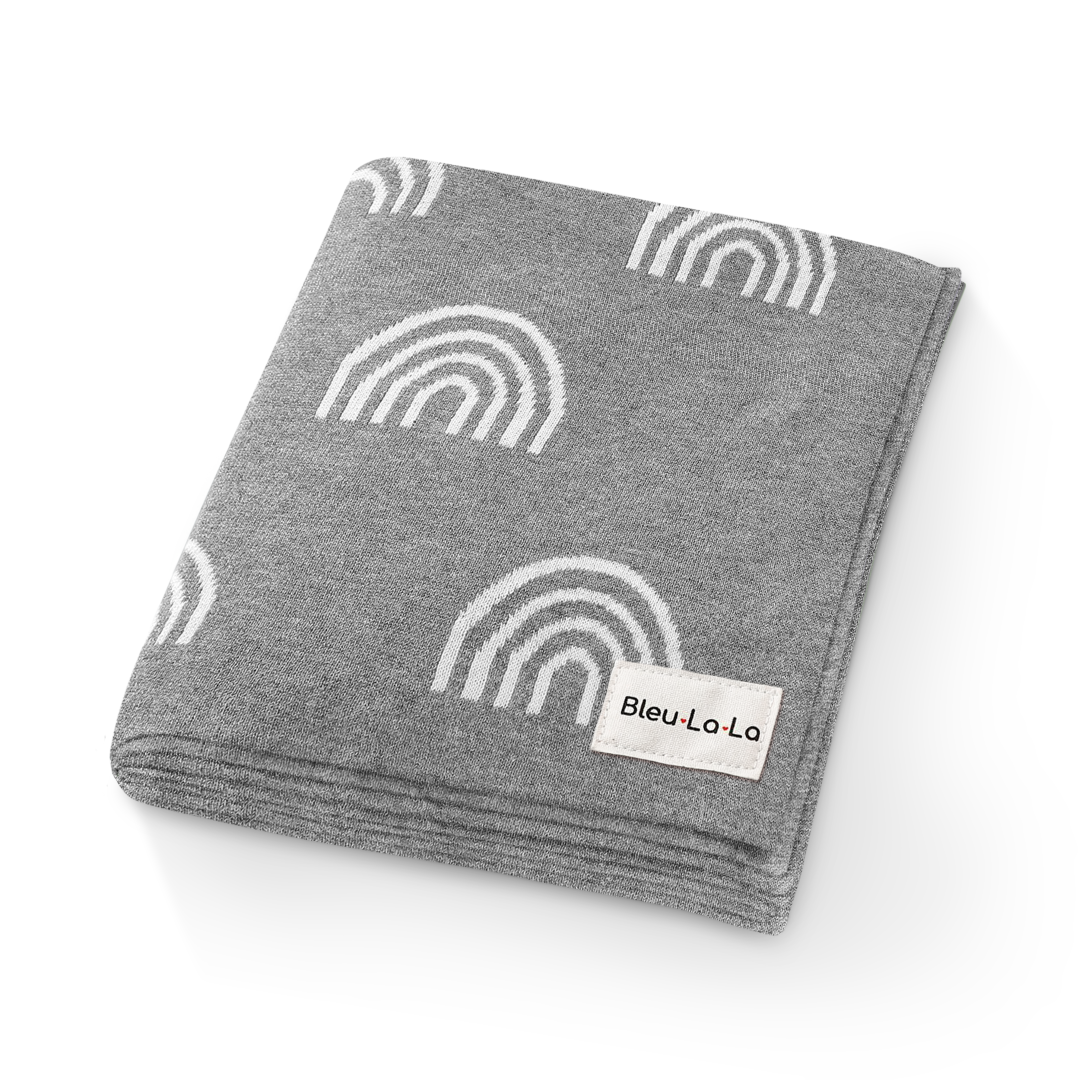 Gray blanket with white rainbow patterns and a visible Bleu-La-La label on a white background