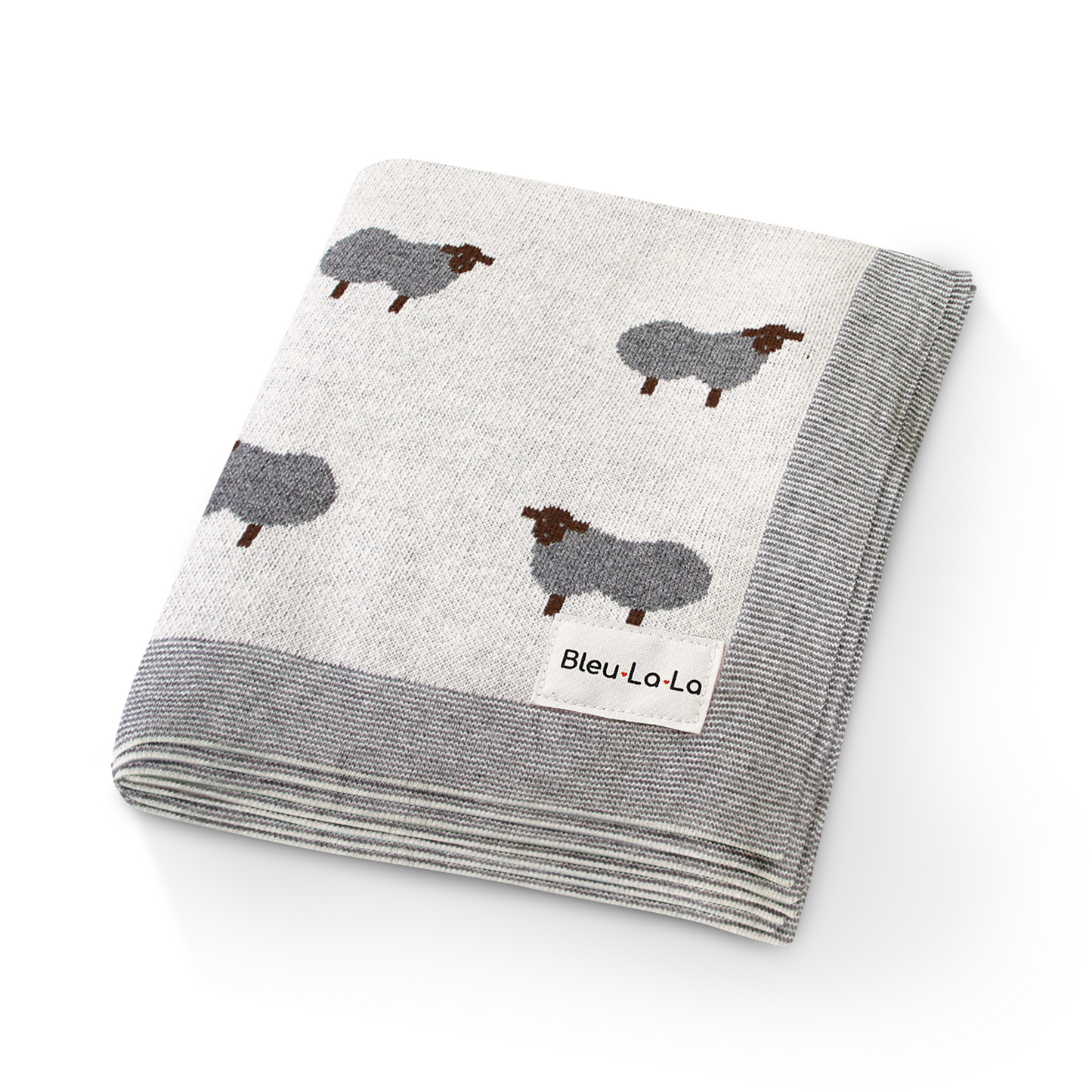 Folded blanket with sheep pattern and 'Bleu Lo La' label on a white background