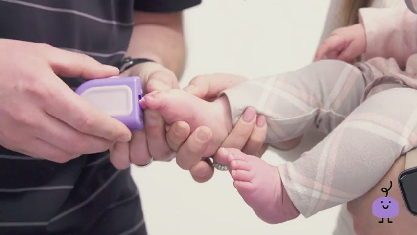A dad is clipping the toenails of his infant mom is holding her. Copy says "Scared of clipping your babies nails? We've Got you covered! A safe, easy to use nail clipper."