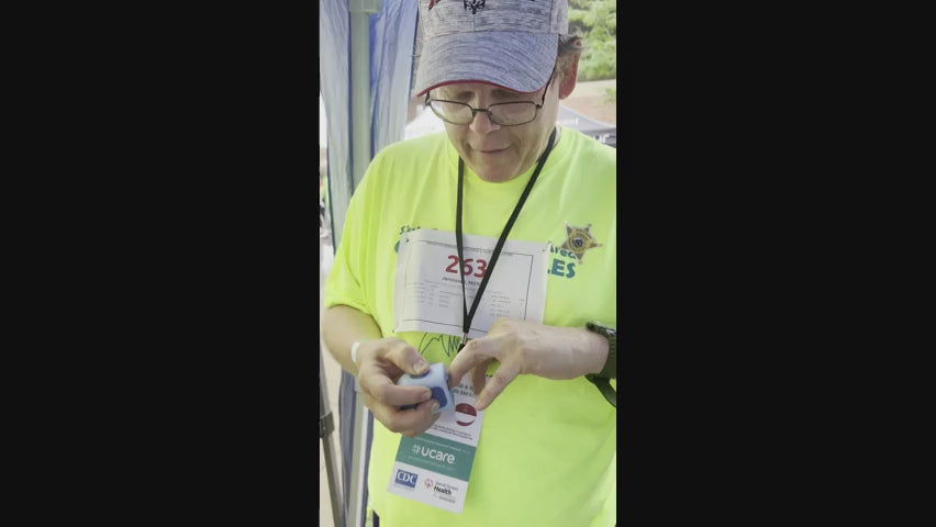 A man at Special Olympics using Lil Nipper Adult size. he's smiling and super surprised how great it is.