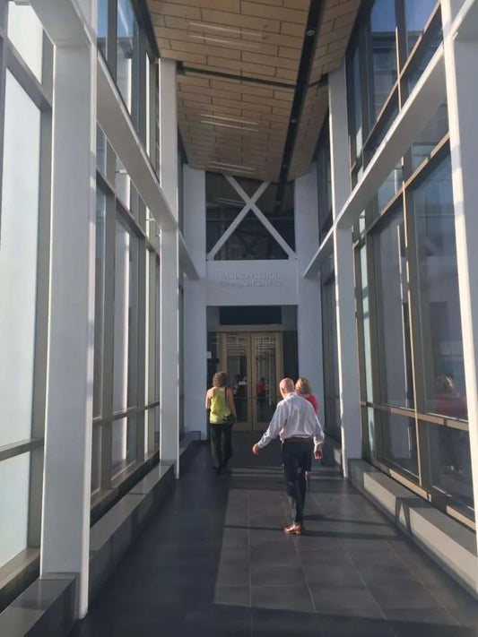 Tom and Melanie walking into building