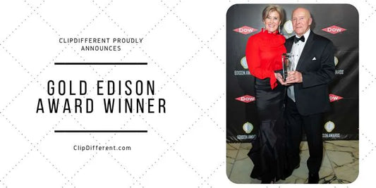 Tom and Melanie standing together holding a gold award. Melanie in a  formal red blouse, long skirt and Tom in a tux.