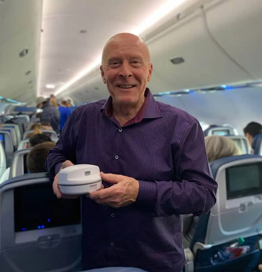 Tom on plane smiling with ClipDifferent Pro in hand