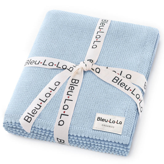 Folded light blue blanket with 'Bleu La La' branding on a white background