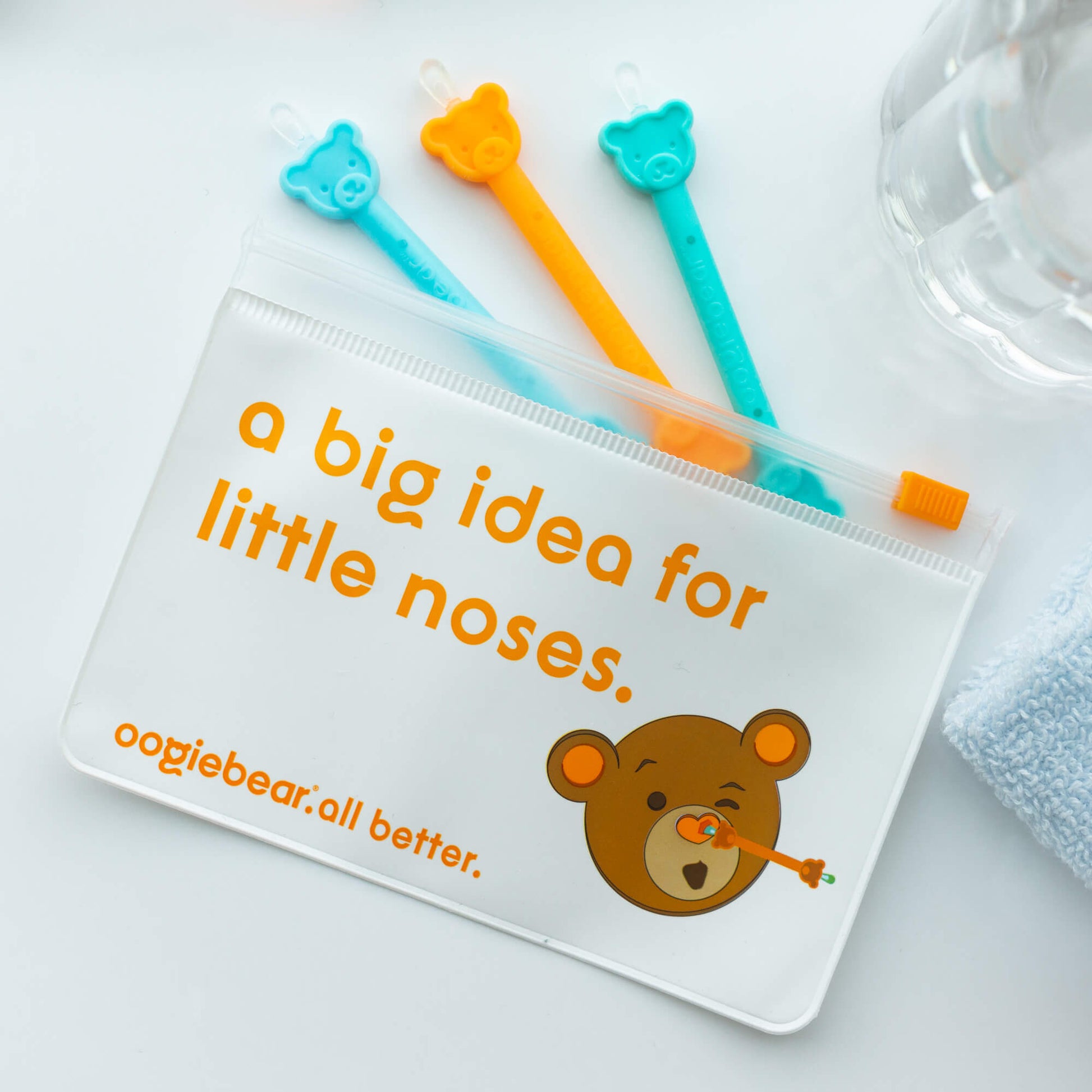 Oogiebear 3-pack booger picker set with storage pouch for travel and organization, labeled 'a big idea for little noses' on a light background.