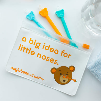 Oogiebear 3-pack booger picker set with storage pouch for travel and organization, labeled 'a big idea for little noses' on a light background.