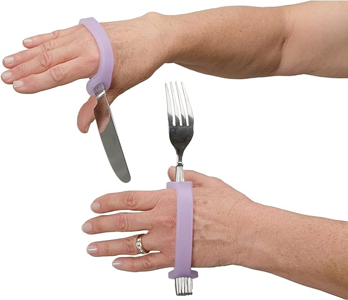 Hands wearing purple EaZyHold grip handles with knife and fork on a white background.