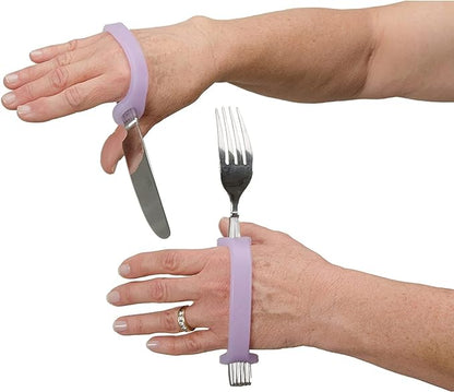 Hands wearing purple EaZyHold grip handles with knife and fork on a white background.