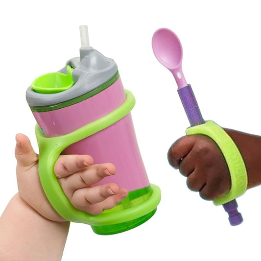 Pink and green sippy cup with straw and purple spoon held by a child's hand with EaZyHold grips on a white background