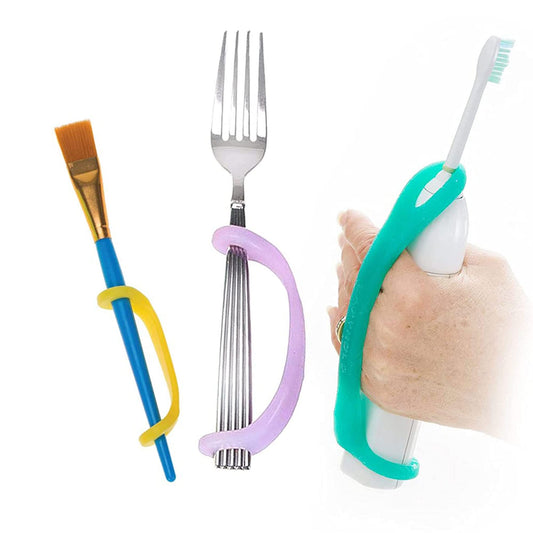 Colorful EaZyHold grip handles attached to a paintbrush, fork, and toothbrush on a white background