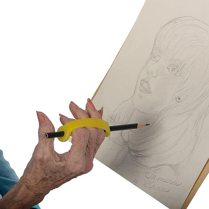 Hand holding a pencil with a yellow EaZyHold grip handle drawing a portrait on paper.