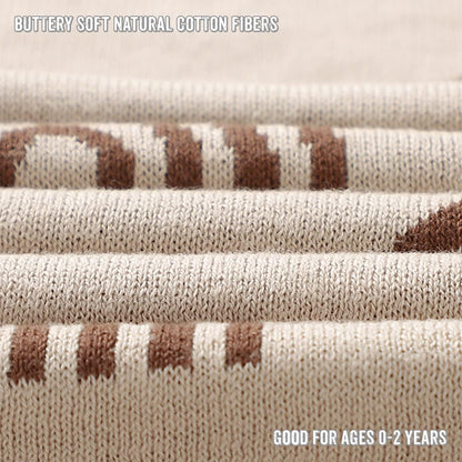 Close-up of textured fabric with brown and beige pattern, labeled 'Buttery soft natural cotton fibers' and 'Good for ages 0-2 years'.