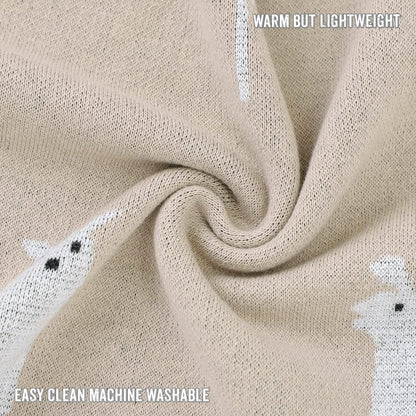 Close-up of beige fabric with embroidered white animals, text indicating warmth and machine washability.