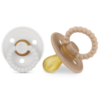 Two baby pacifiers, one white and one beige, on a white background