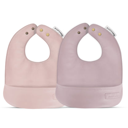 Two pink Classic set of soft vegan leather easy clean baby bibs with adjustable snaps on a white background