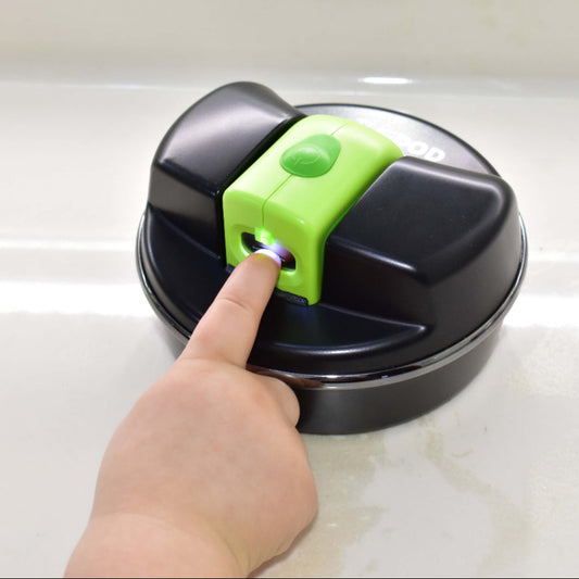 Image of school-aged hand using the Lil Nipper and POD, inserting fingernail into slot and POD is resting on a table.