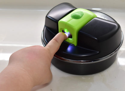 A young child is using the Pod with a green child size Lil Nipper. The bright LED light is shining on the little finger and their nail is inside the safety slot being trimmed.
