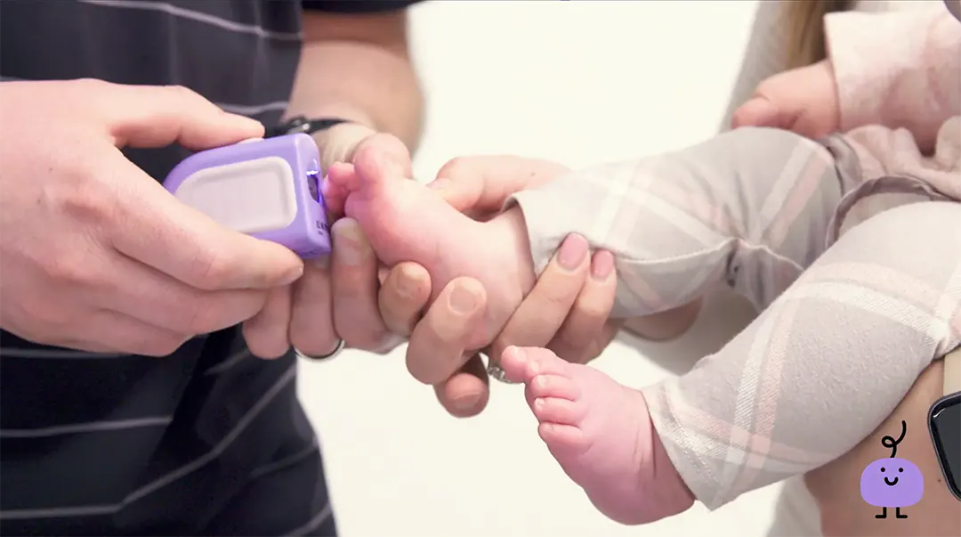 A baby's foot with the Lil Nipper electric nail clipper