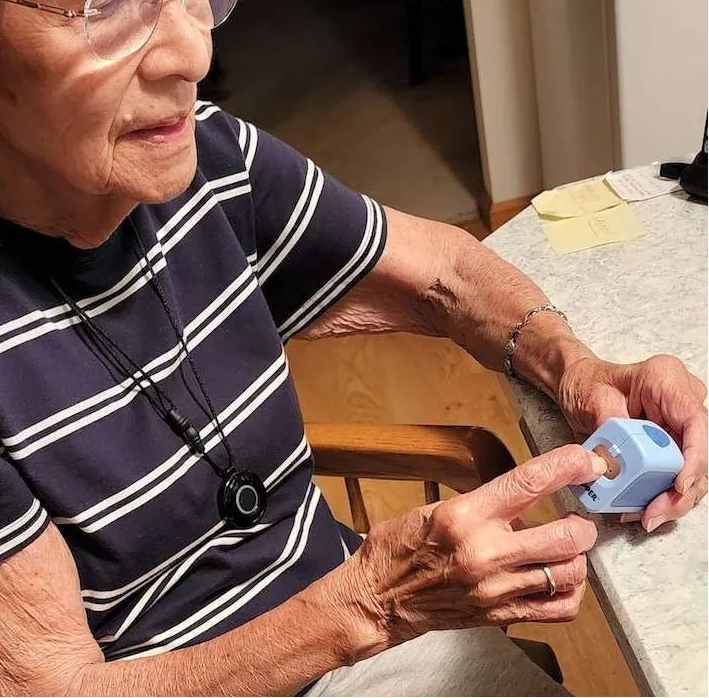 Senior woman using Lil Nipper and cutting her nails.