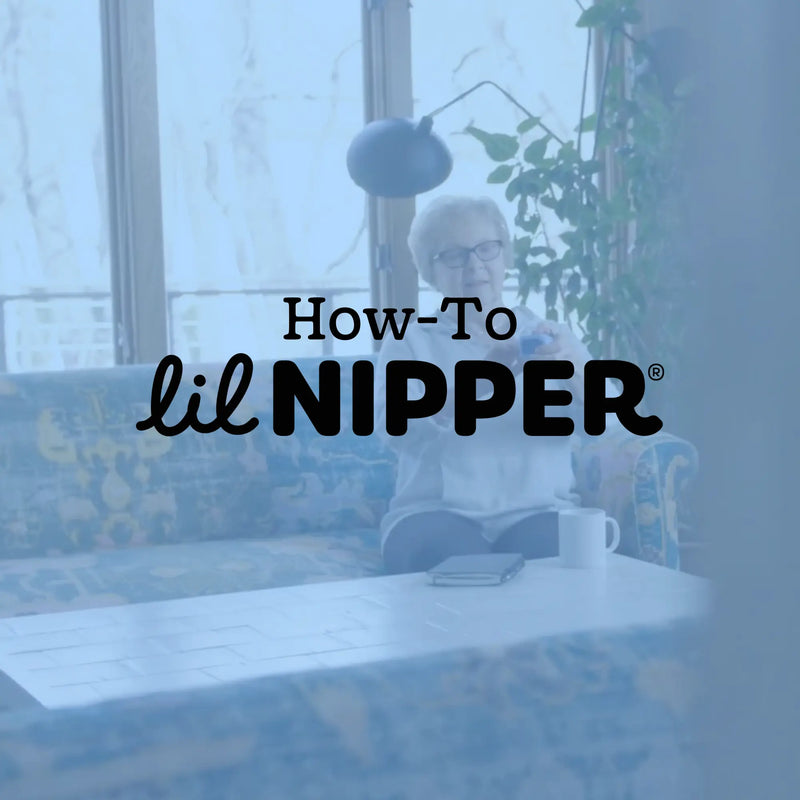 Senior woman using Lil Nipper electric nail clipper at home - arthritis-friendly adaptive nail care device.