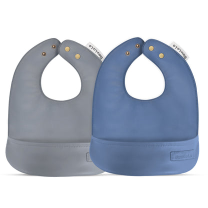Classic set of soft vegan leather easy clean baby bibs with adjustable snaps one gray and one blue, on a white background.