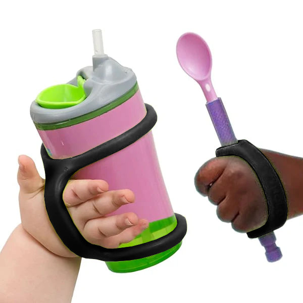 Child holding a pink sippy cup and purple spoon with black EaZyHold grips on a white background.