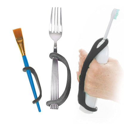 Black EaZyHold grip handles attached to a fork, paintbrush, and toothbrush on a white background.