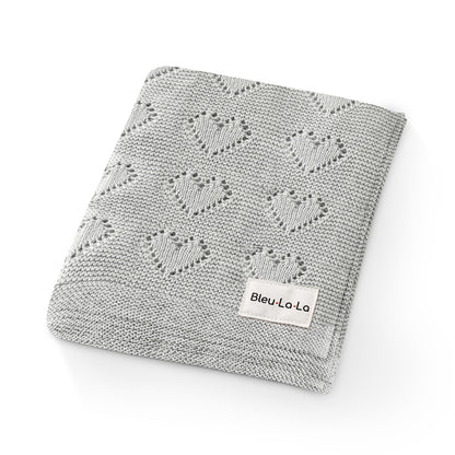 Gray knitted blanket with heart patterns and a visible Bleu-la-la  label on a white background