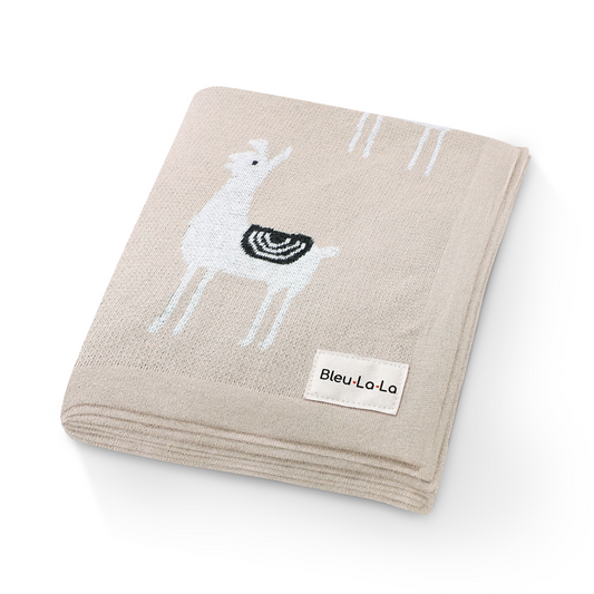 Beige baby blanket with a llama design and Bleu La La label on a white background
