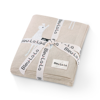 Folded beige blanket with 'Bleu La La' branding on a white background