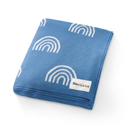 Folded blue fabric with white rainbow patterns and Blel-La-La on a white background
