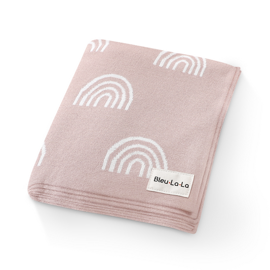 Pink blanket with white rainbow patterns and 'Bleu La La' label on a white background