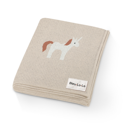 Beige blanket with unicorn design and Bleu Lo La label on a white background