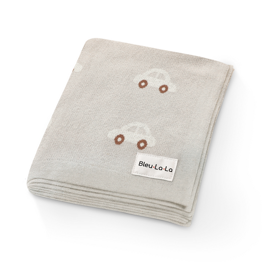 00% cotton luxury knit car swaddle blanket with adorable car pattern design with a small white Bleu-la-la label on a white background