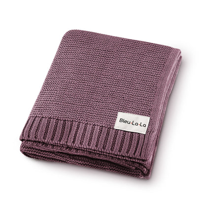 Folded purple blanket with a visible Blue-La-La label on a white background