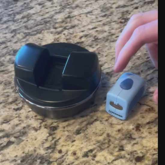 A video of an adult with one hand inserting the Lil Nipper Adult size in blue color into the pod. Turns on the Lil Nipper, inserts fingernail and trims nails quickly. Turns off, slides open bottom and dumps out their clippings.