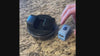 A video of an adult with one hand inserting the Lil Nipper Adult size in blue color into the pod. Turns on the Lil Nipper, inserts fingernail and trims nails quickly. Turns off, slides open bottom and dumps out their clippings.