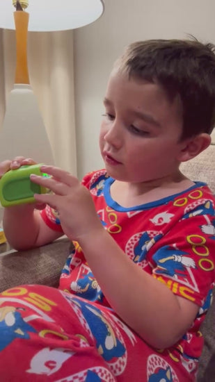 A child using the Lil Nipper, Close-up of the Lil Nipper Child clipper, showing its compact size and safety shield.