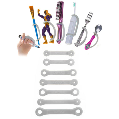 Grey EazyHold grips with a variety of household items including a brush, fork, spoon, paint brush, marker, and toy figurine.
